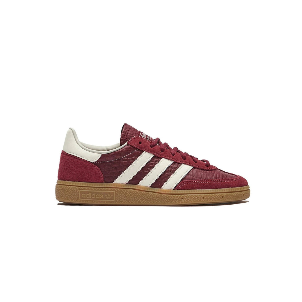 Maroon Adidas sneaker with white stripes on a white background