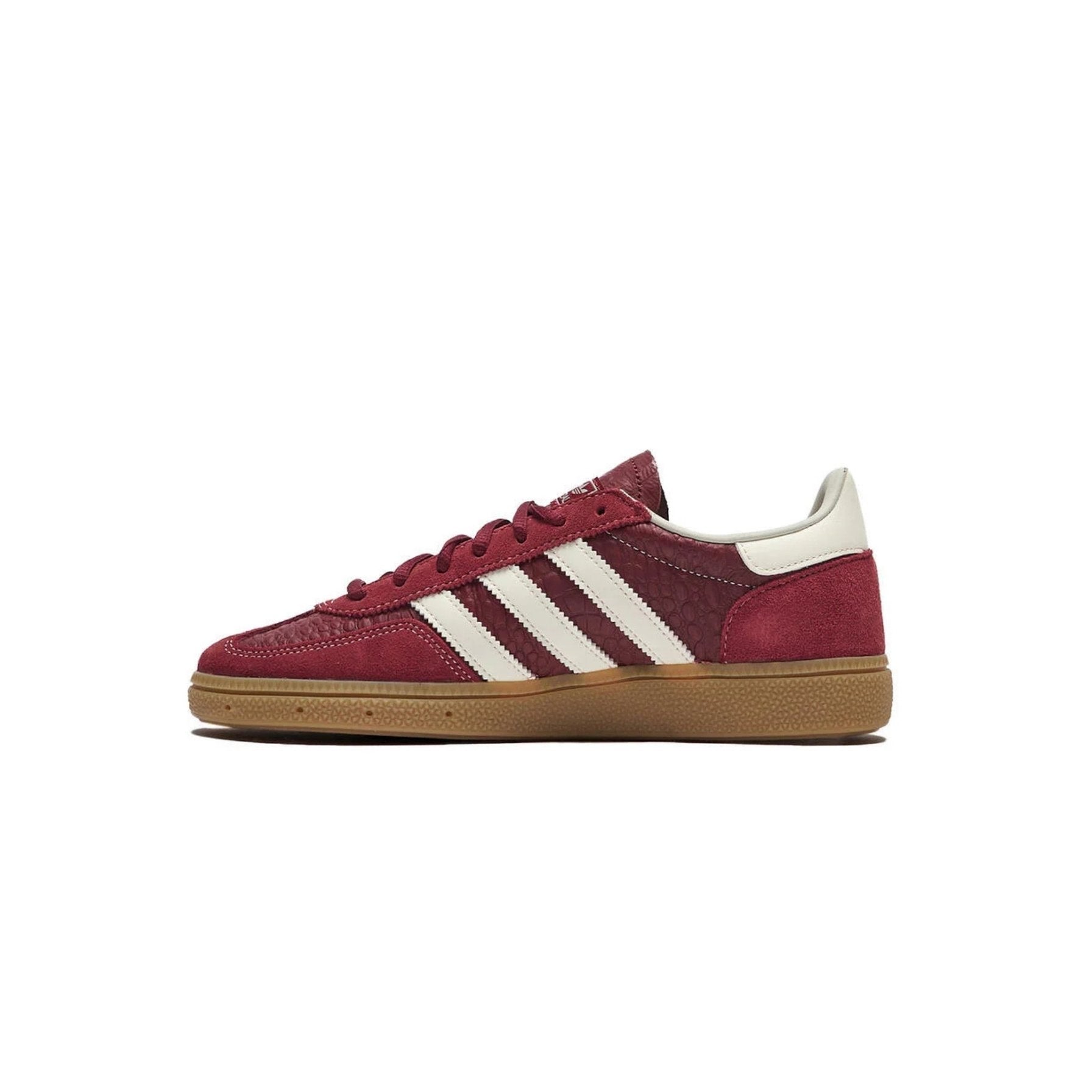 Maroon Adidas sneaker with white stripes on a white background