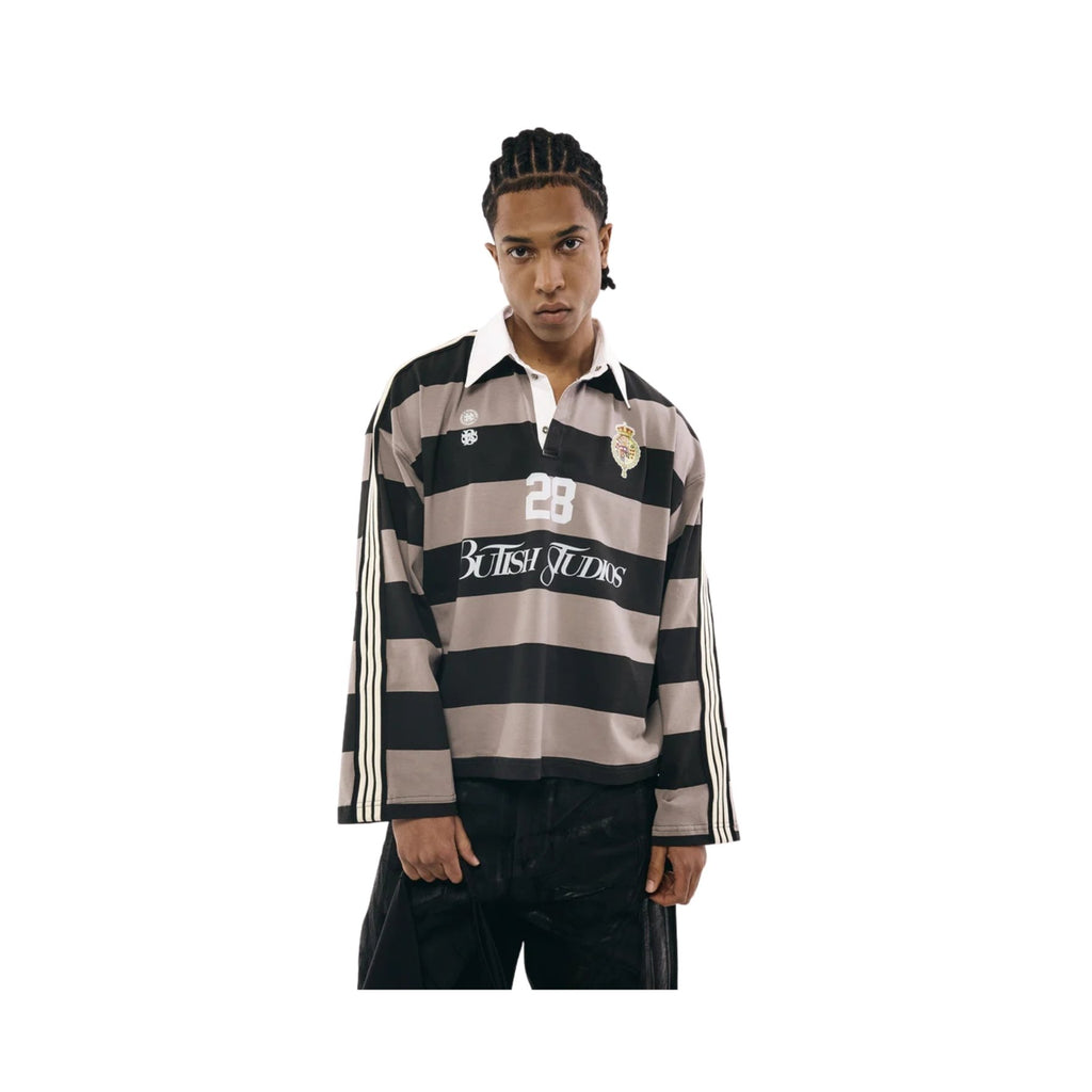 Person wearing a striped rugby shirt with visible branding on a white background