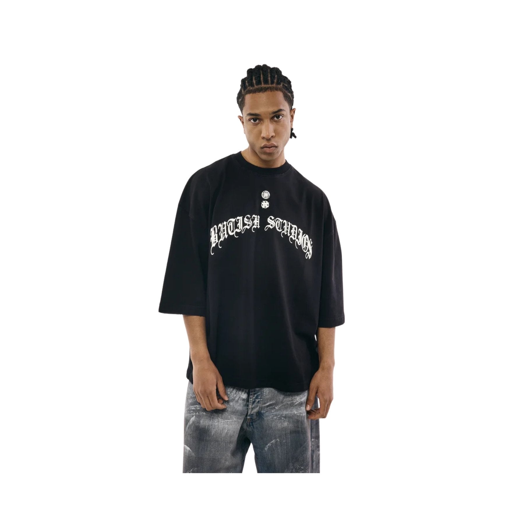 Person wearing a black oversized t-shirt with white text on a white background
