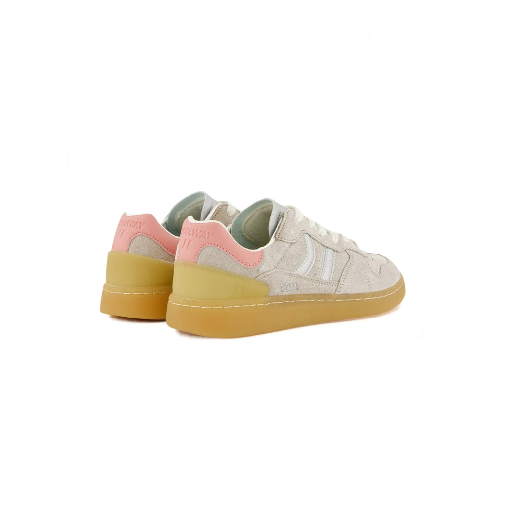A pair of low-top sneakers shown from the side, featuring a light beige suede upper, a pastel pink heel tab, and a translucent yellow gum sole.