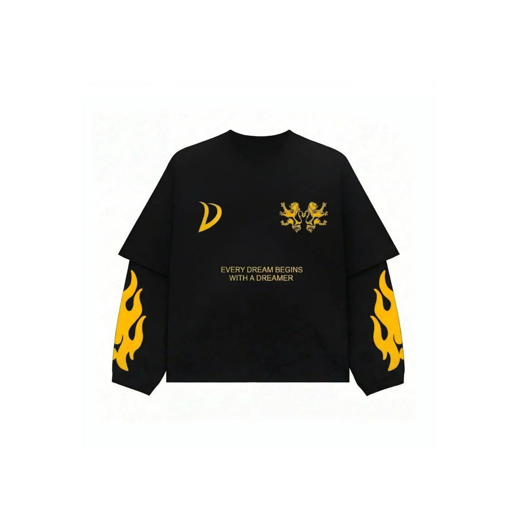 A black long-sleeve t-shirt with yellow graphic prints, including a crescent moon on the right chest, a double-headed arrow on the left chest, the text 'EVERY DREAM BEGINS WITH A DREAMER' in the center, and yellow flame patterns on both sleeves.