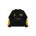 A black long-sleeve t-shirt with yellow graphic prints, including a crescent moon on the right chest, a double-headed arrow on the left chest, the text 'EVERY DREAM BEGINS WITH A DREAMER' in the center, and yellow flame patterns on both sleeves.