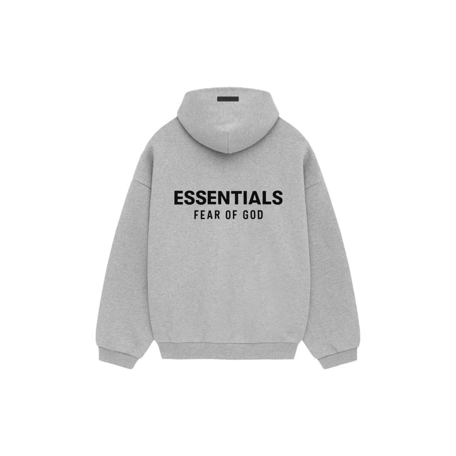 A light gray heather pullover hoodie shown from the back, featuring the text 'ESSENTIALS' and 'FEAR OF GOD' printed in black across the upper back.