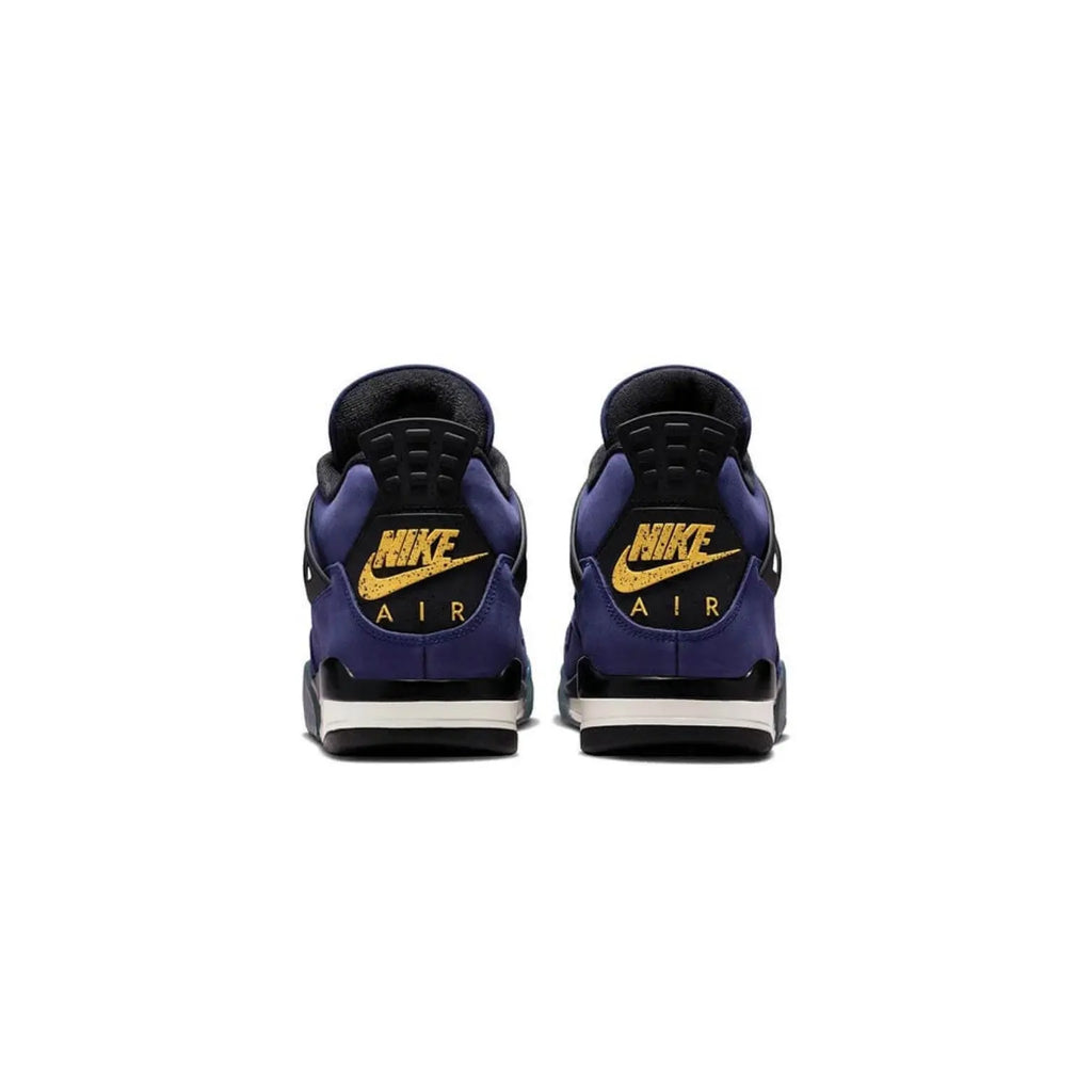 A pair of Nike Air sneakers shown from the back, featuring a deep purple and black upper with metallic gold Nike branding and swooshes, set against a plain white background.