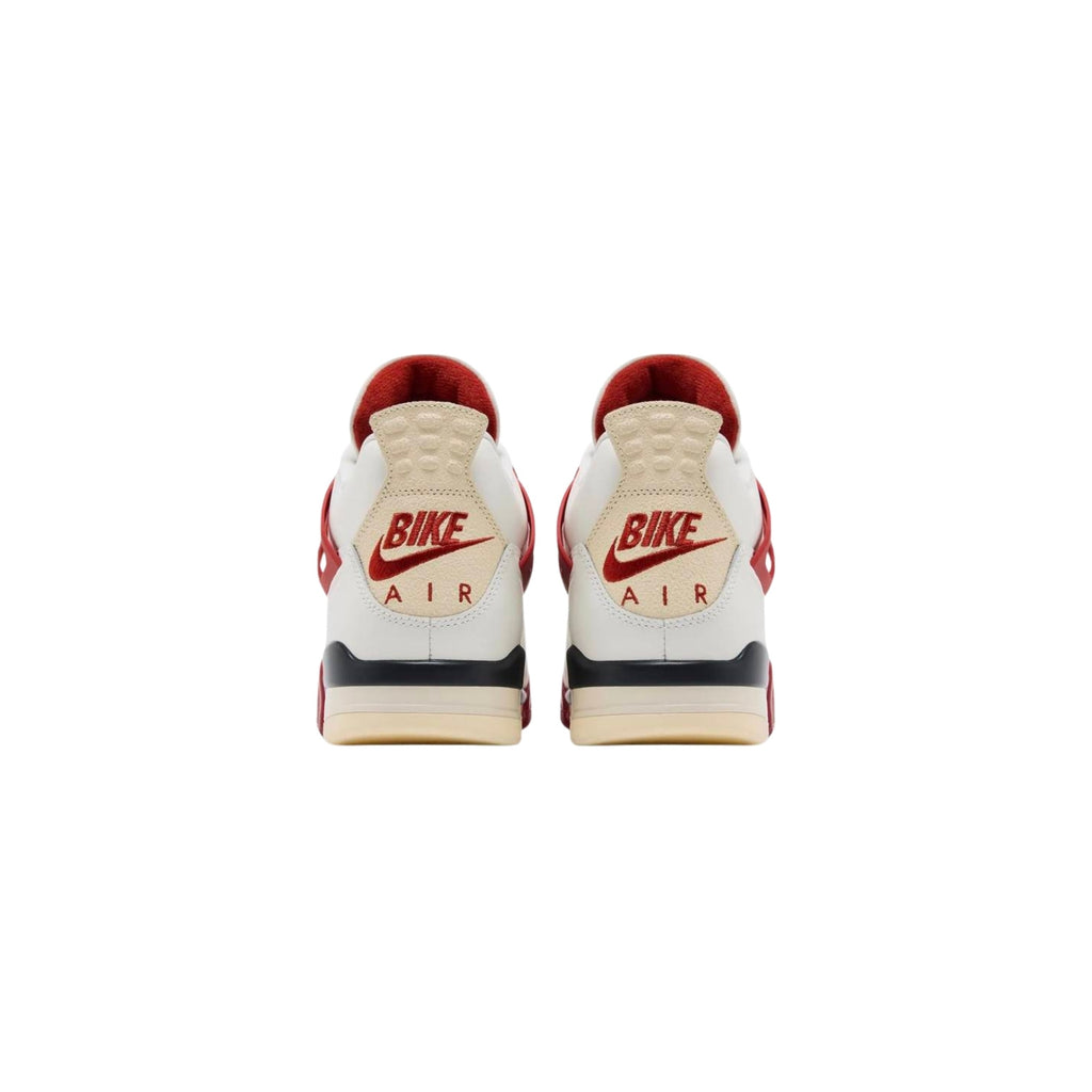 Pair of white sneakers with red and black accents on a white background