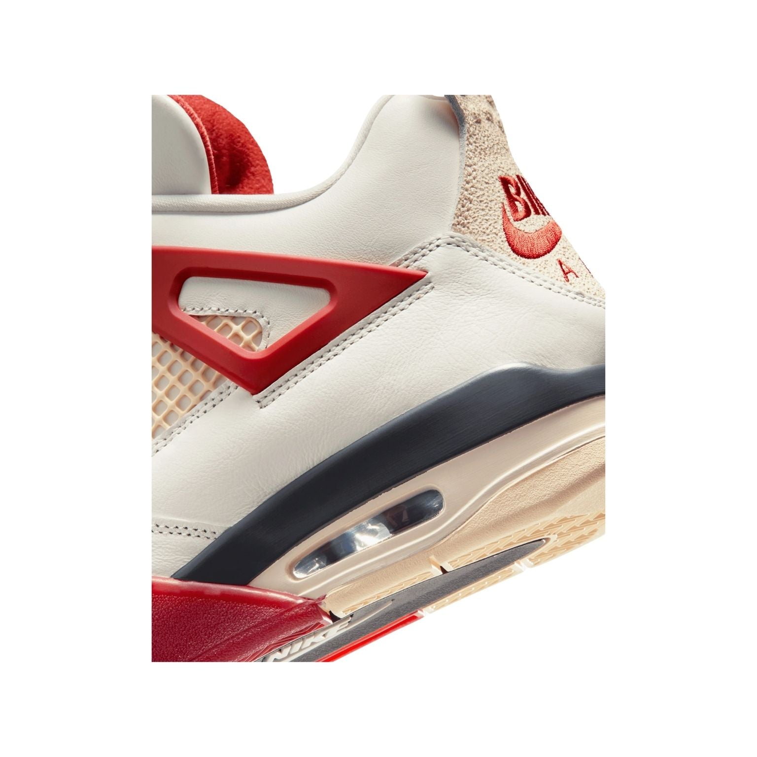 Close-up of a sneaker with red and black accents on a white background