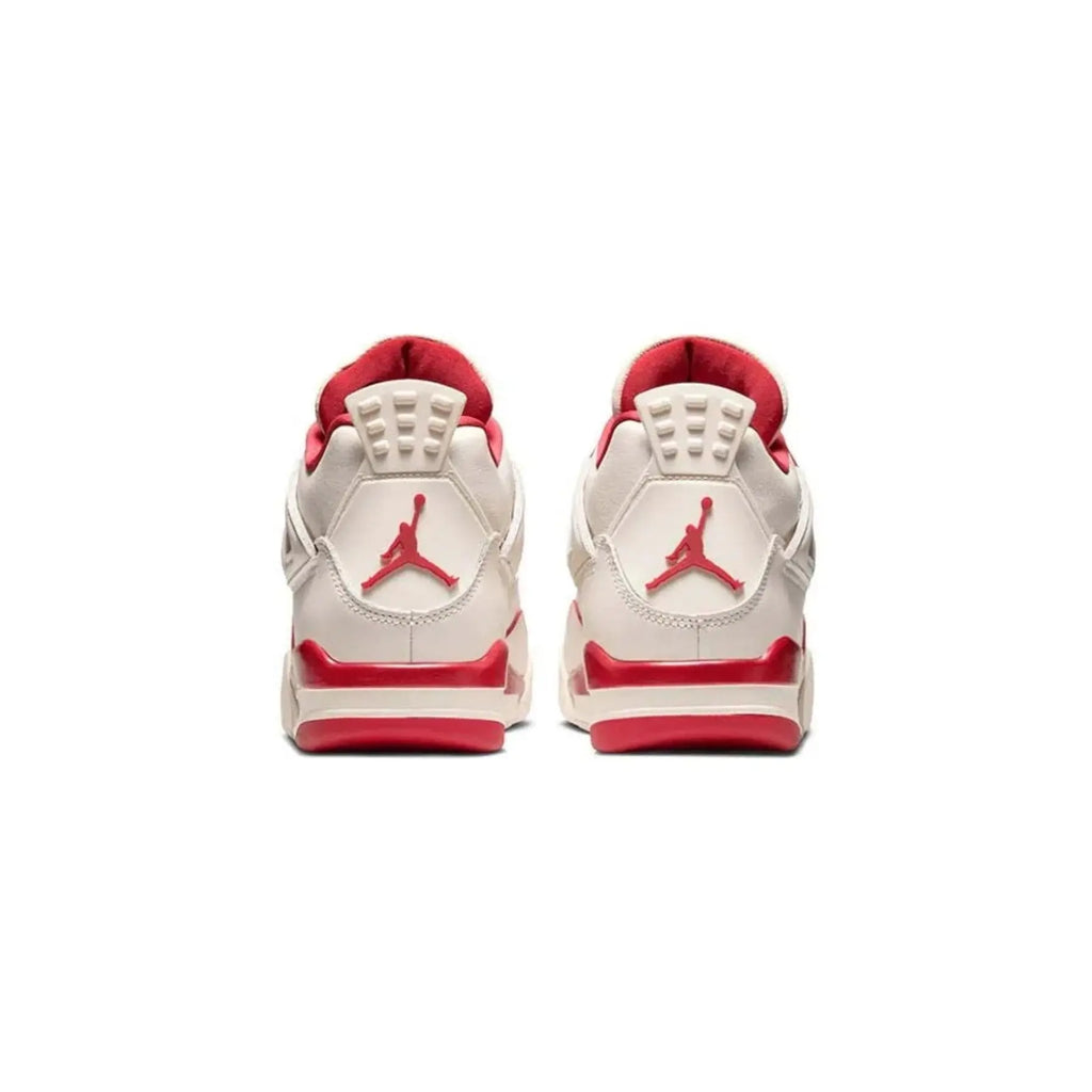 Pair of red and white sneakers with a prominent logo on a white background