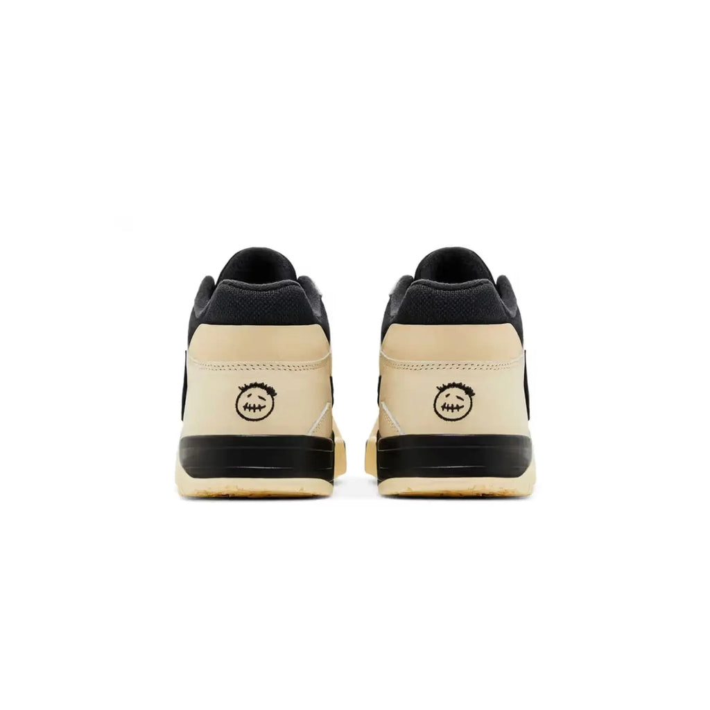 Pair of black and beige sneakers on a white background