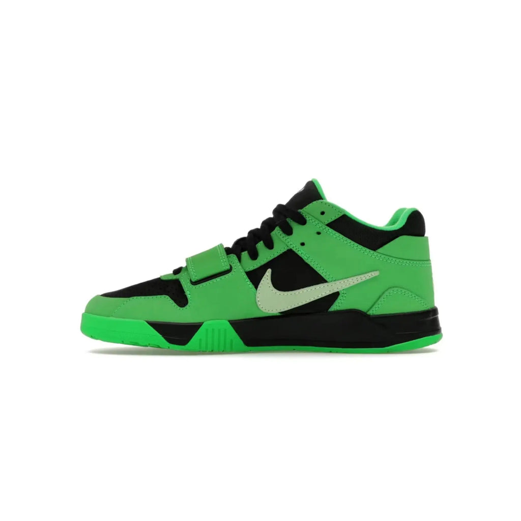 Green and black sneaker with a white logo on a white background