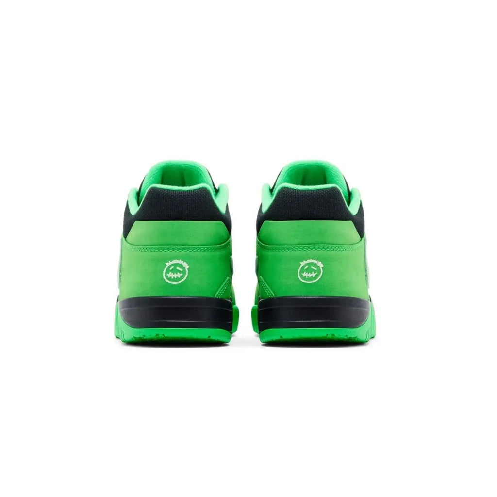 Green sneakers with black soles on a white background