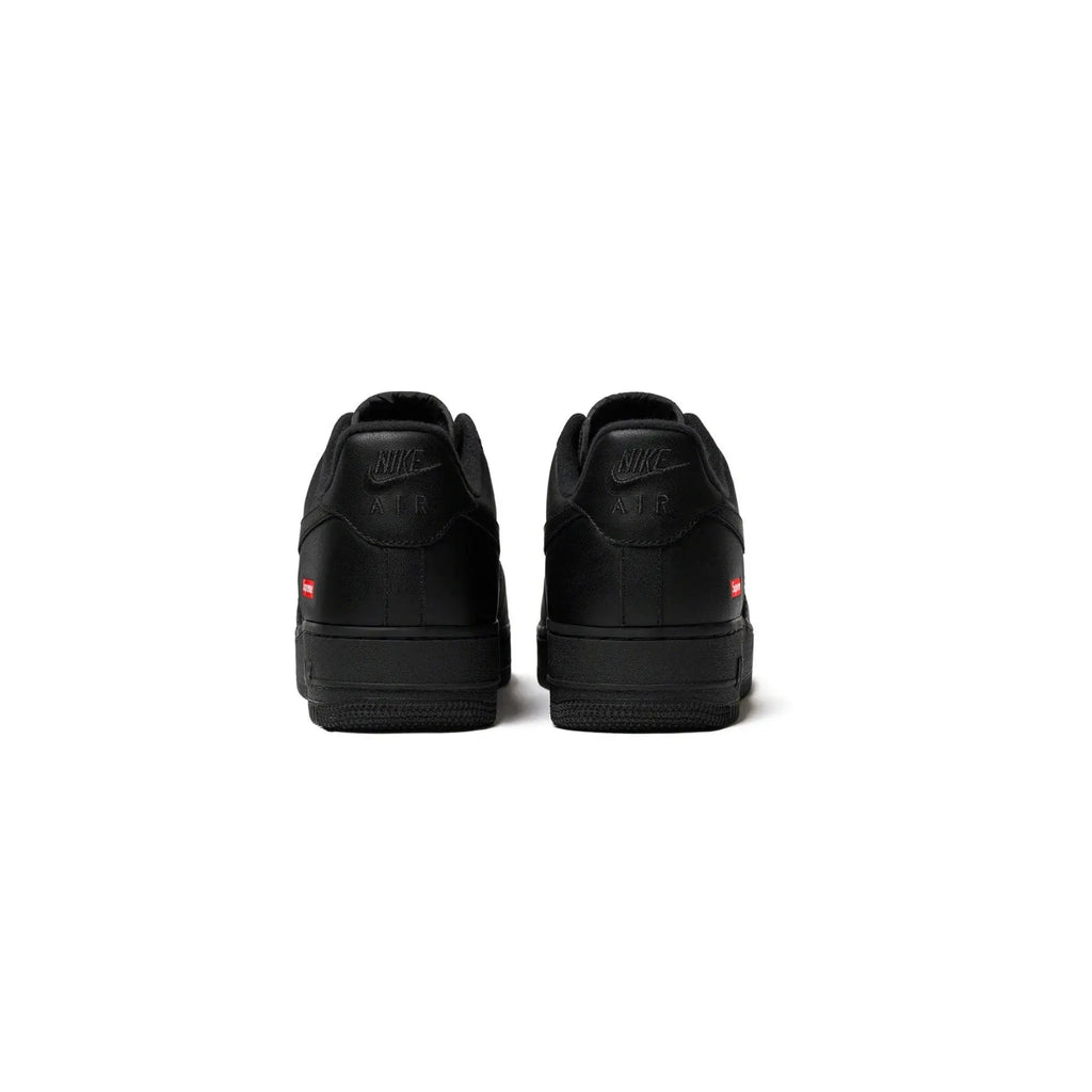 Black sneakers with a brand logo on a white background