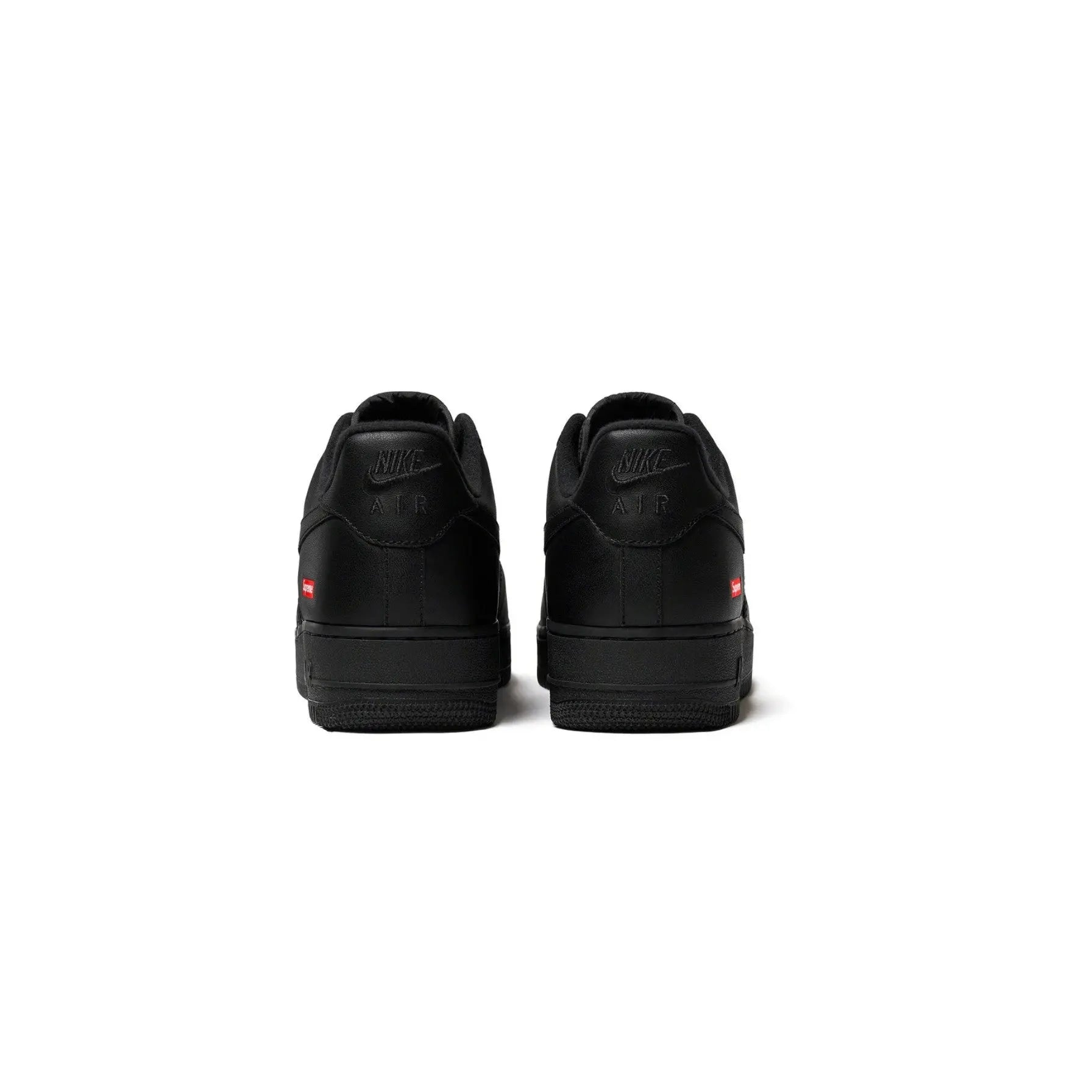 Black sneakers with a brand logo on a white background