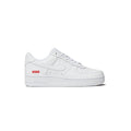 White sneaker with a red and blue label on a white background