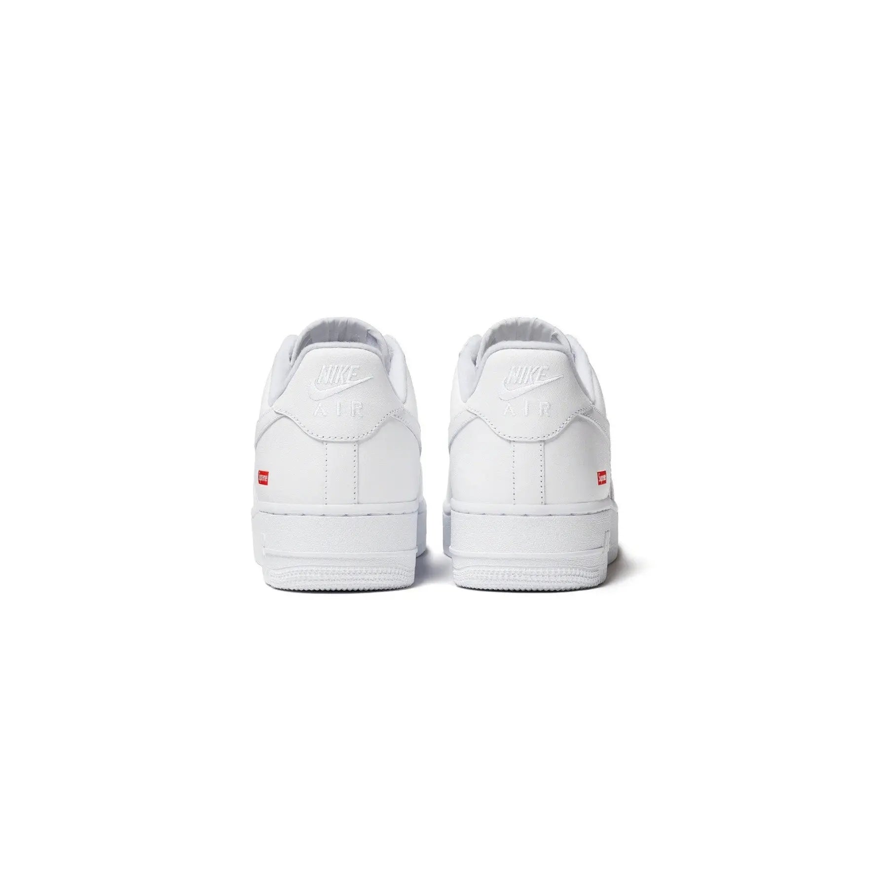 White sneakers with a brand logo on a white background