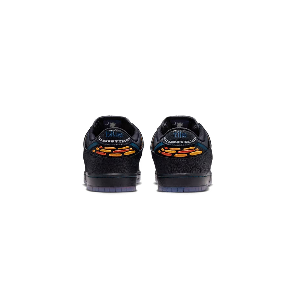 Black sneakers with orange accents on a white background