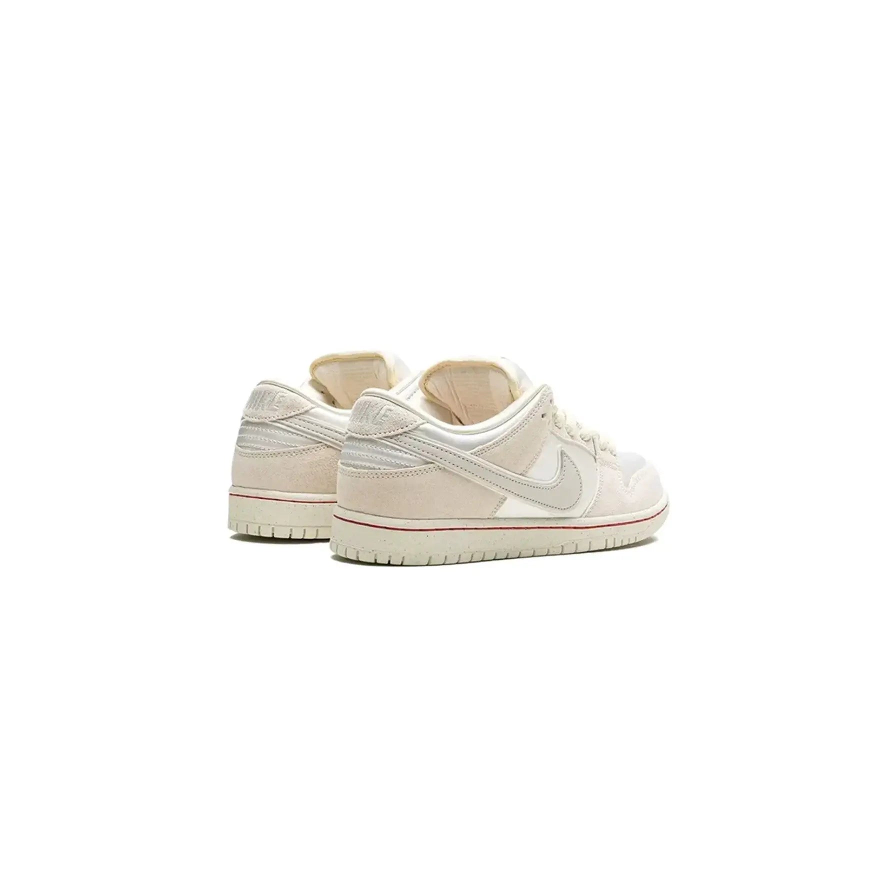 Pair of beige and white sneakers on a white background