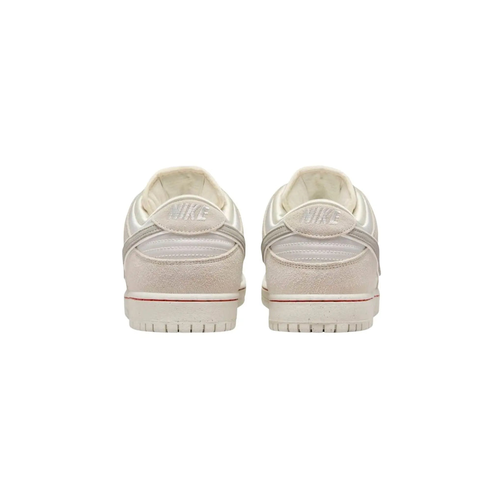 Pair of white sneakers on a white background