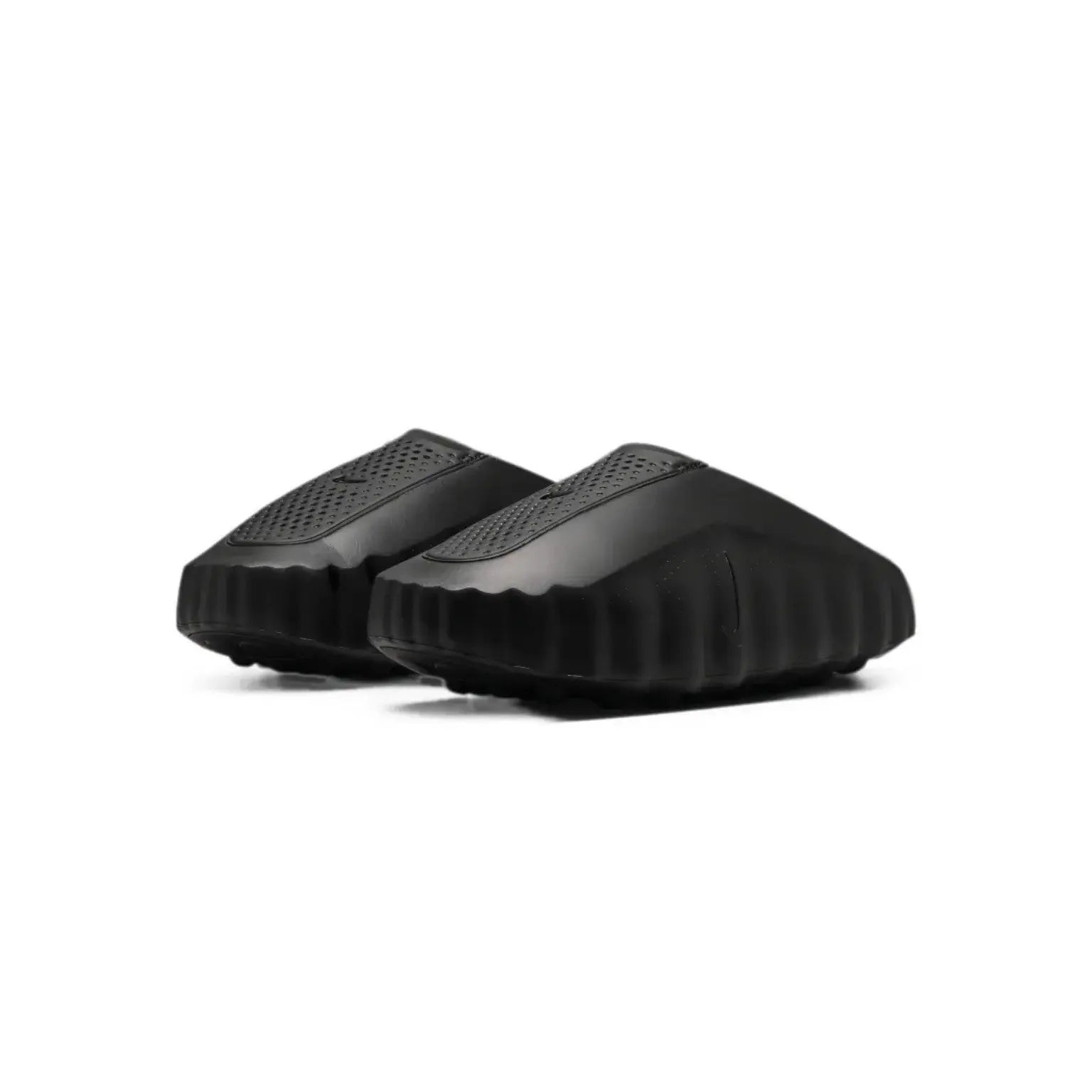 A pair of black slip-on clogs with textured, ribbed soles and perforated upper panels, shown on a plain white background.