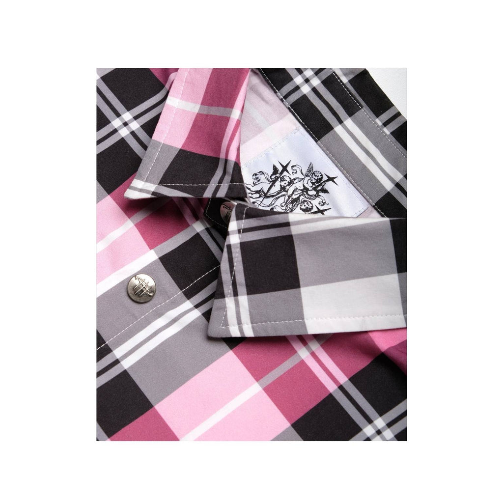 Close-up of a plaid shirt with a button and embroidered design on a white background