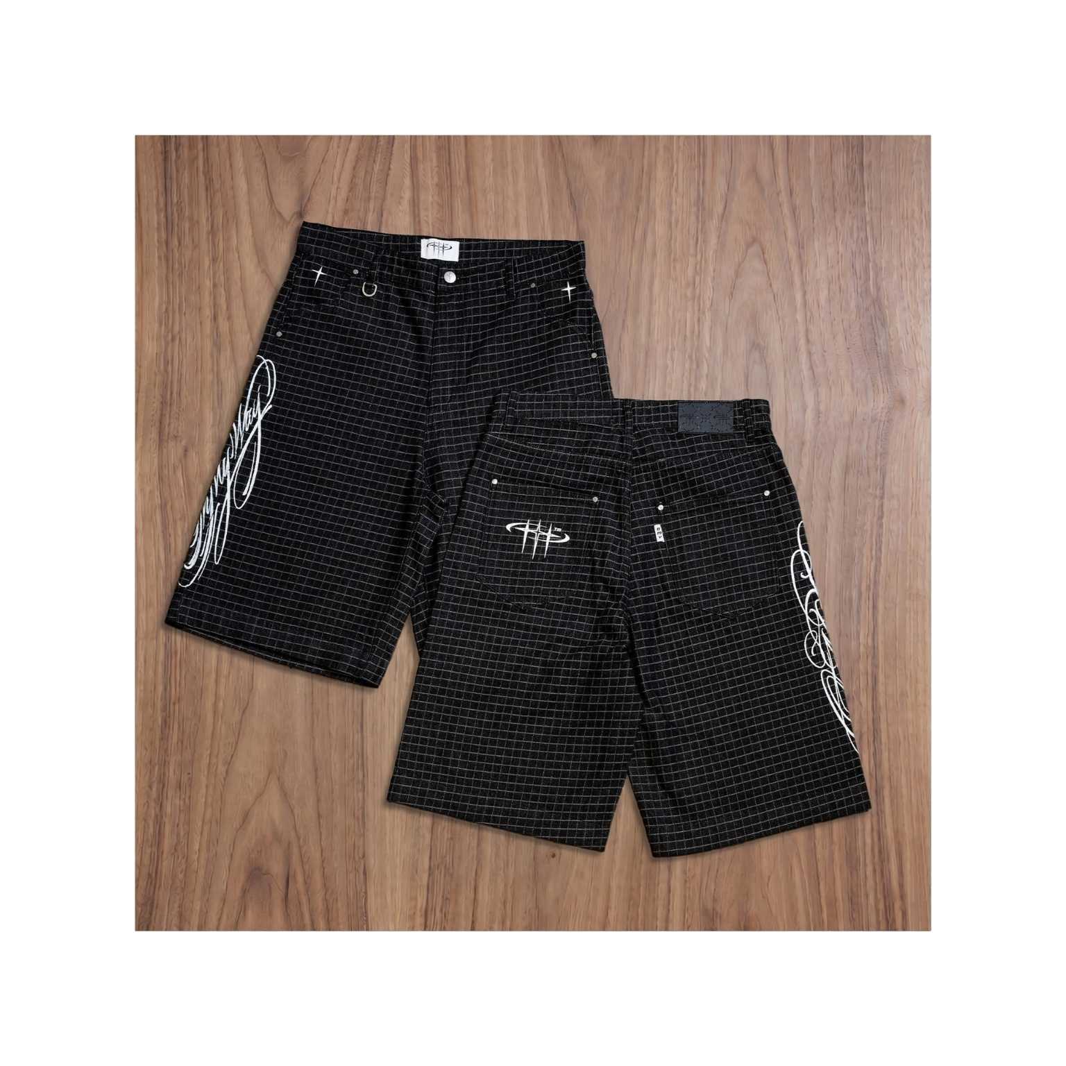 Black checkered shorts with white designs on a wooden surface