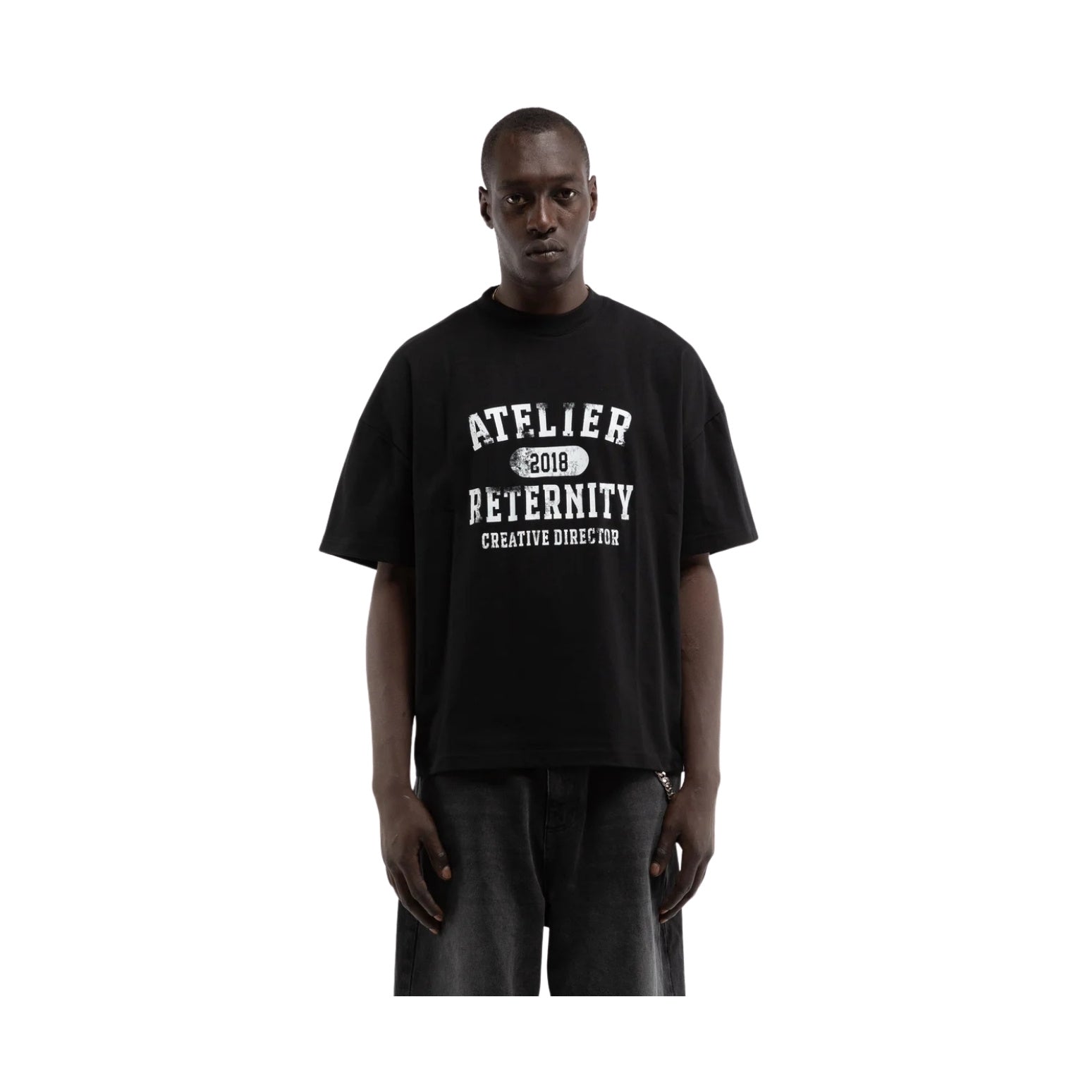 Person wearing a black t-shirt with white text on a white background
