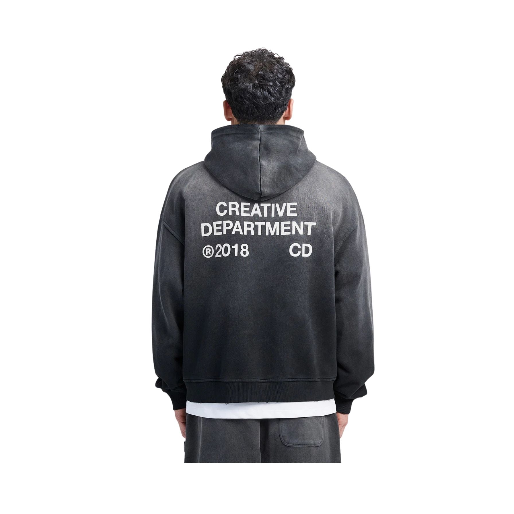 Person wearing a black hoodie with 'Creative Department @2018 CD' text on the back, on a white background
