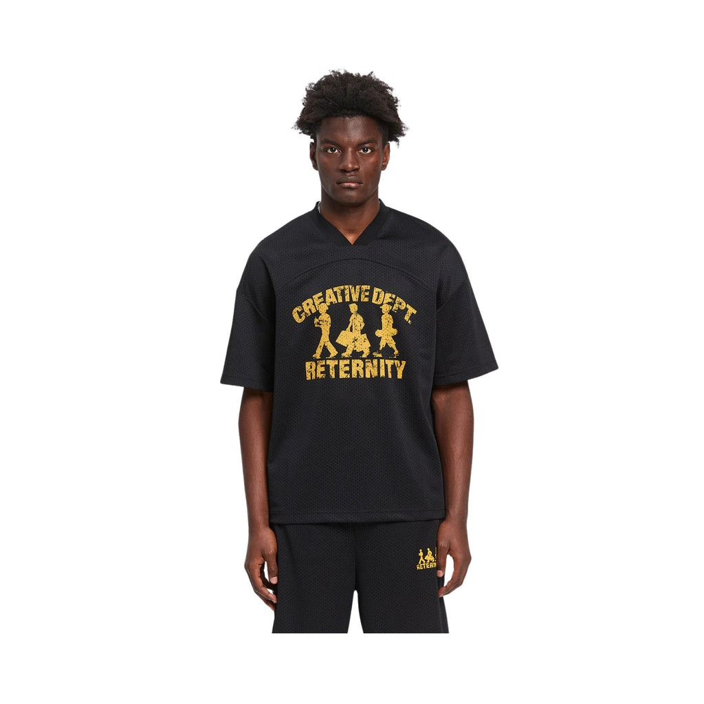 Person wearing a black t-shirt with yellow text and graphics on a white background
