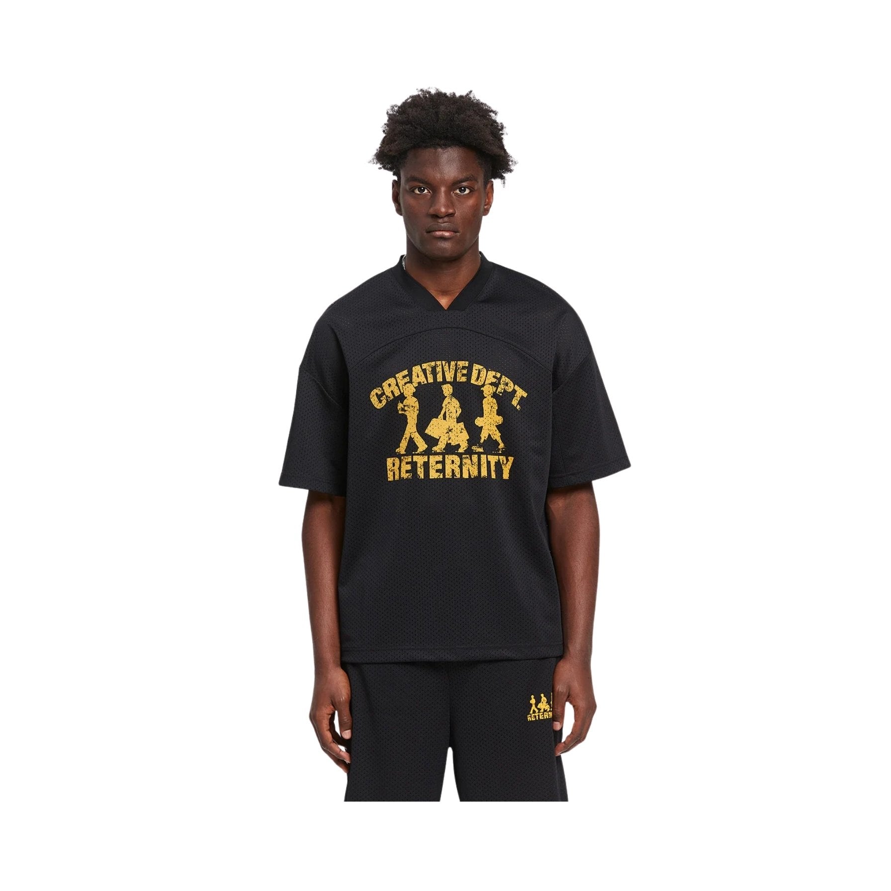 Person wearing a black t-shirt with yellow text and graphics on a white background