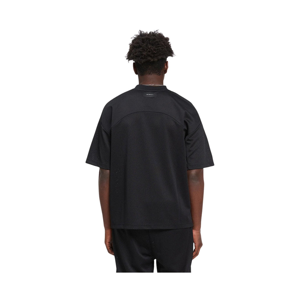 Person wearing a black t-shirt and pants on a white background