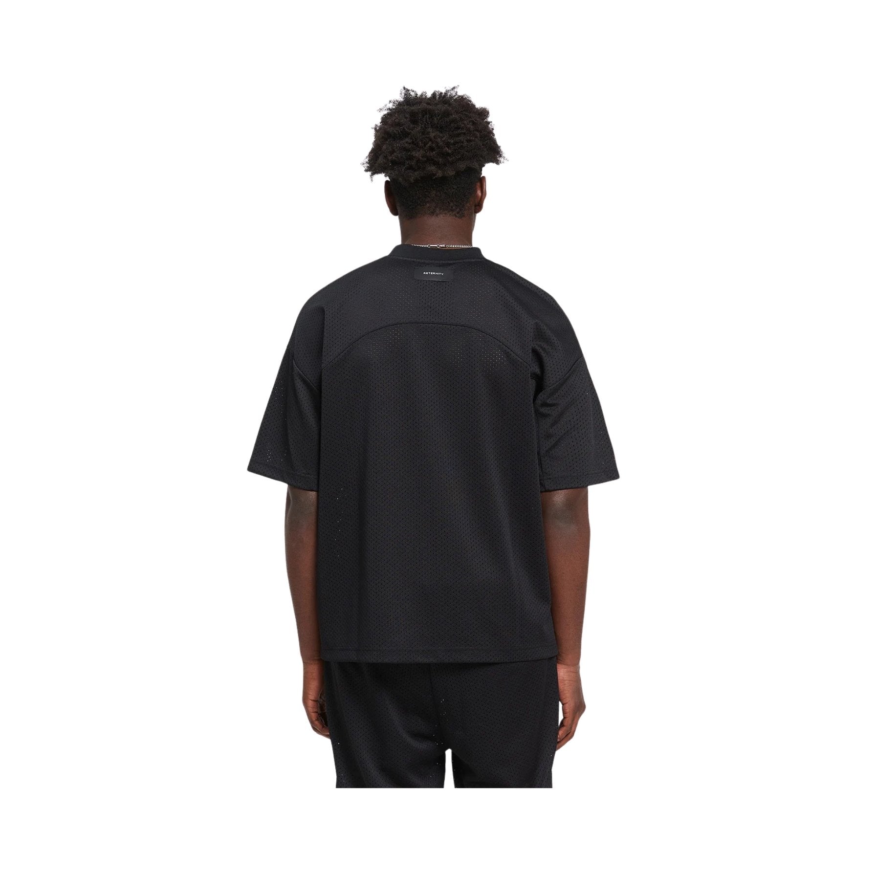 Person wearing a black t-shirt and pants on a white background