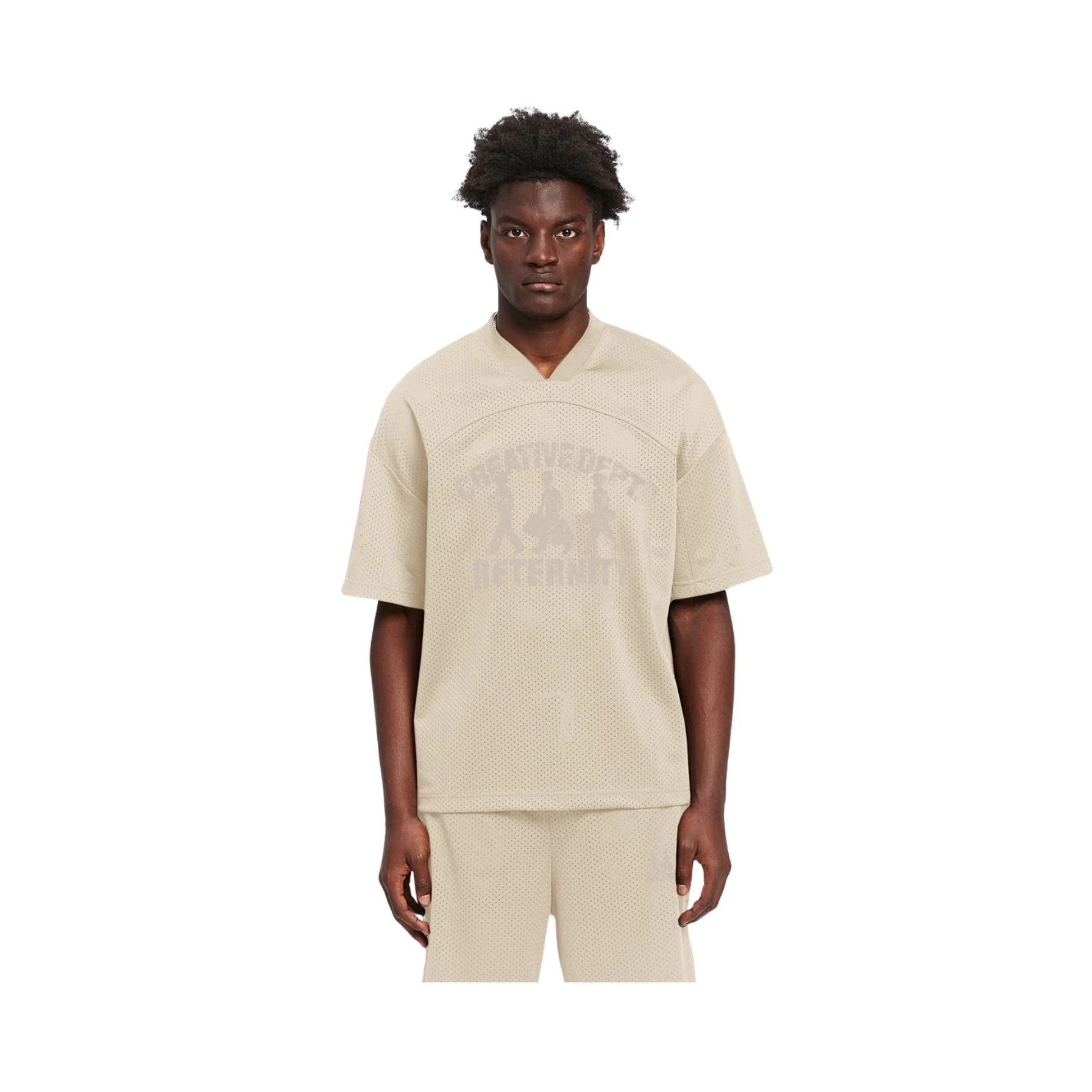 Person wearing a beige outfit with a brand logo on a white background