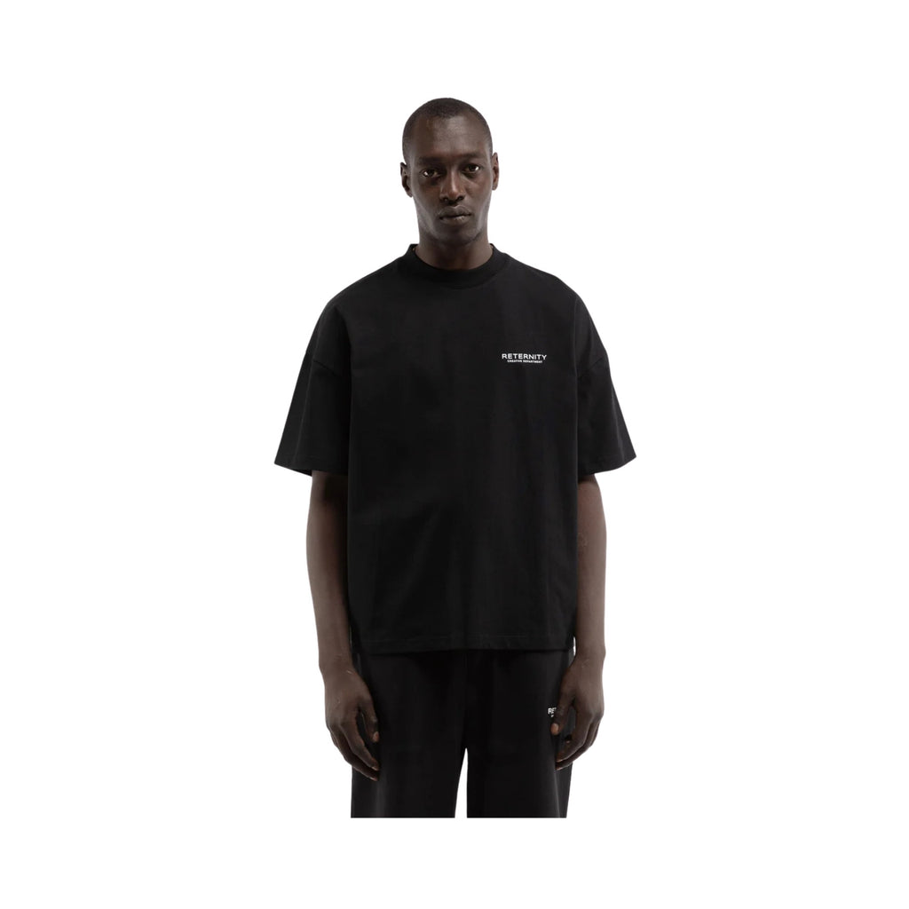 Person wearing a black t-shirt with a logo on a white background