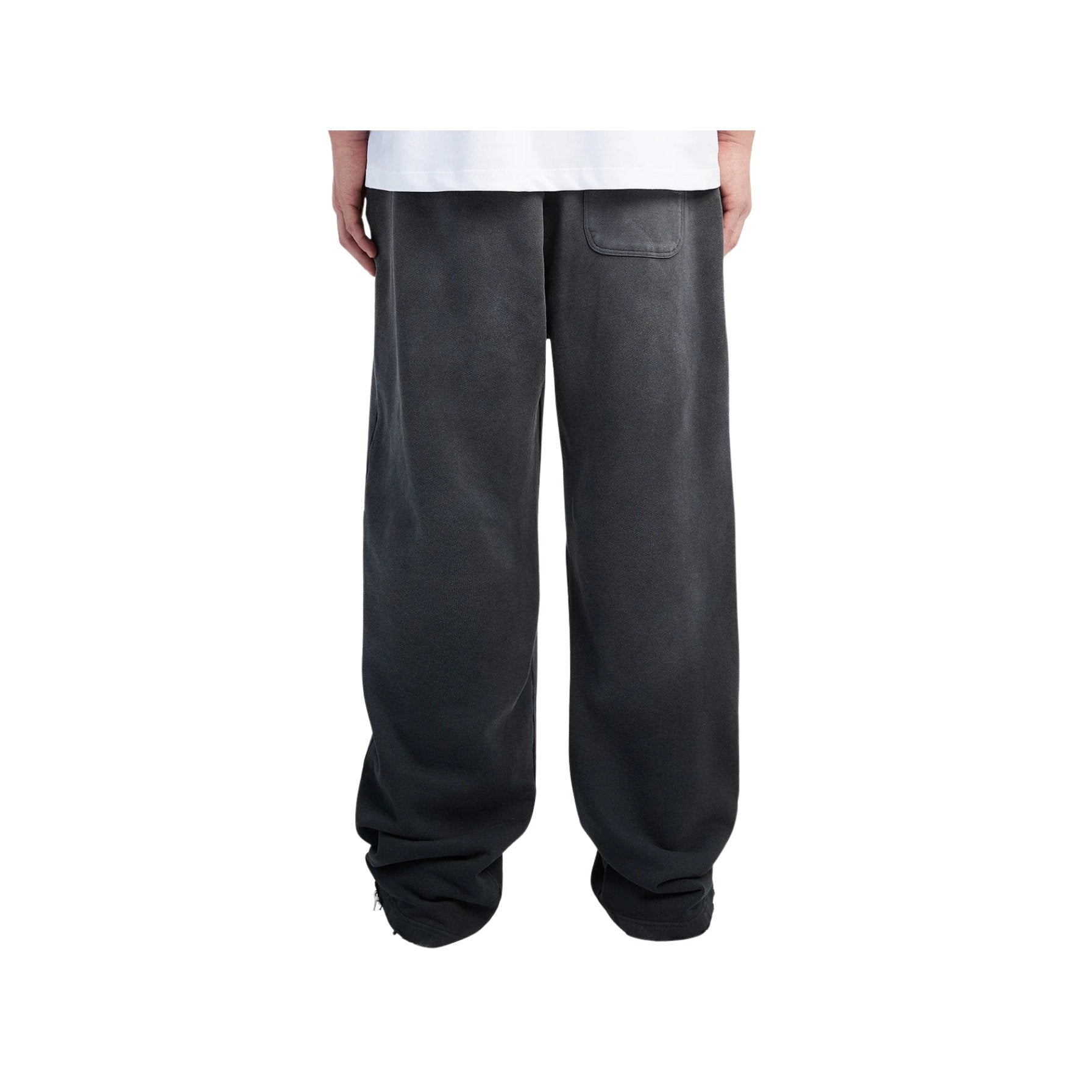 Person wearing dark gray sweatpants on a white background