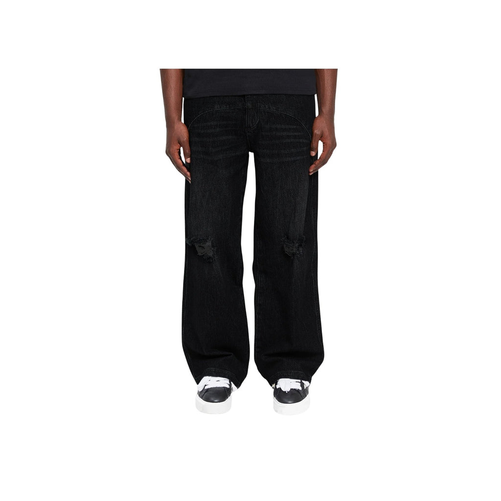 Black wide-leg jeans worn by a person on a white background