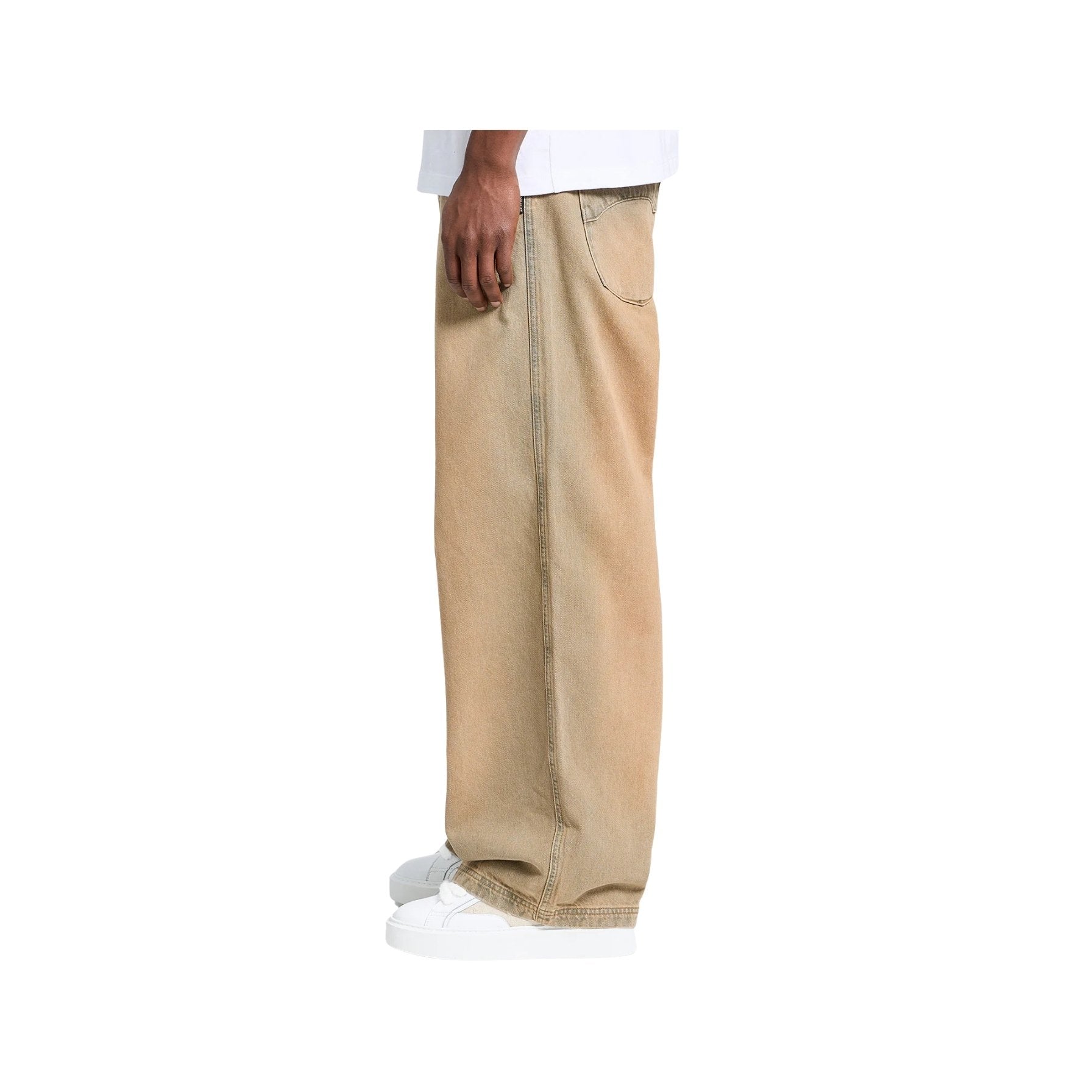 Beige pants worn by a person on a white background