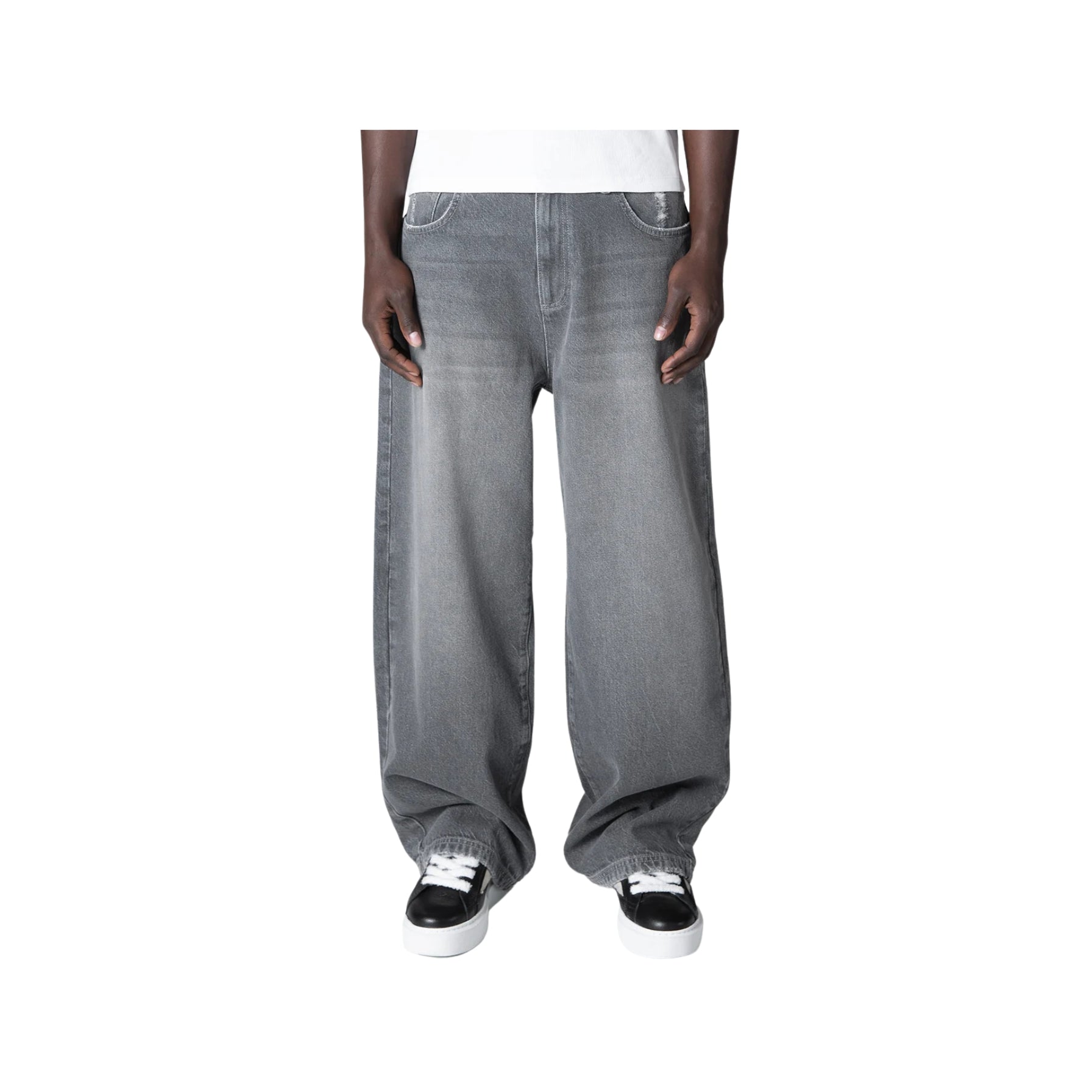Gray baggy jeans worn by a person on a white background