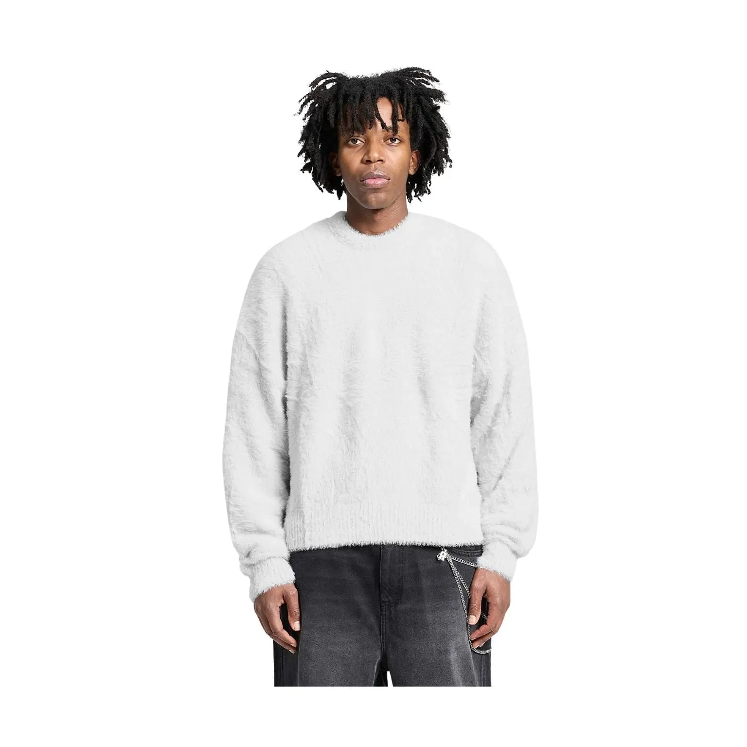 A man with black dreadlocks wearing a light gray fuzzy crewneck sweater and dark gray jeans, standing against a solid white background.