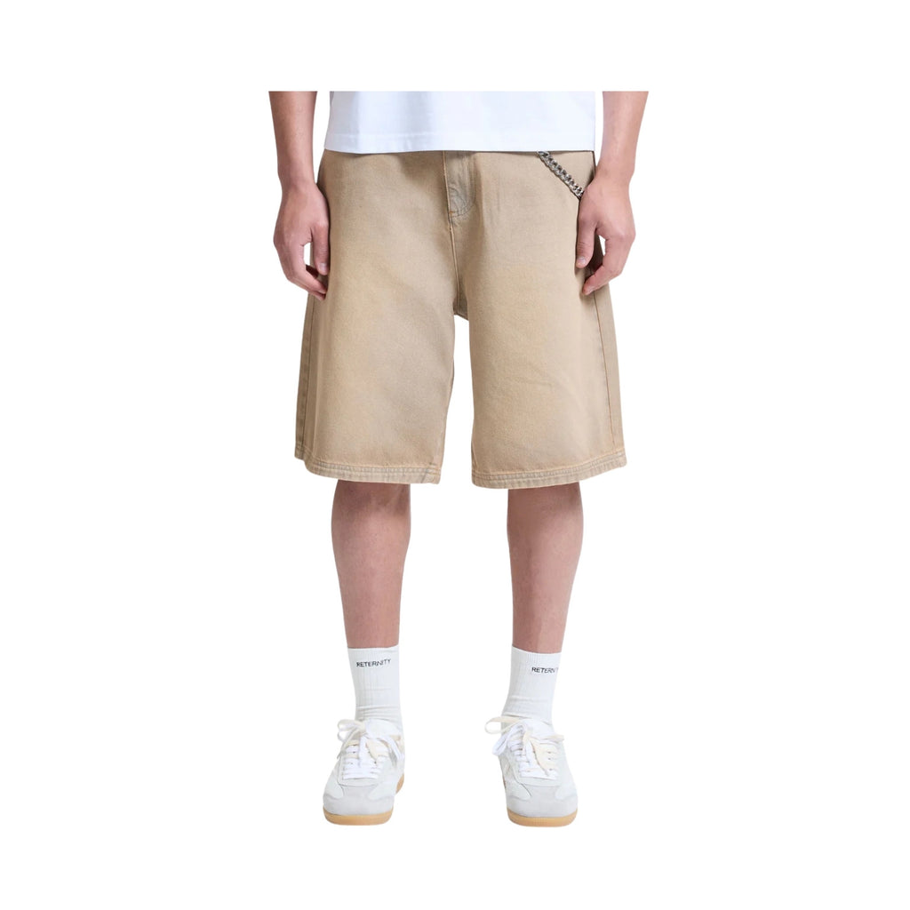 Person wearing beige shorts on a white background