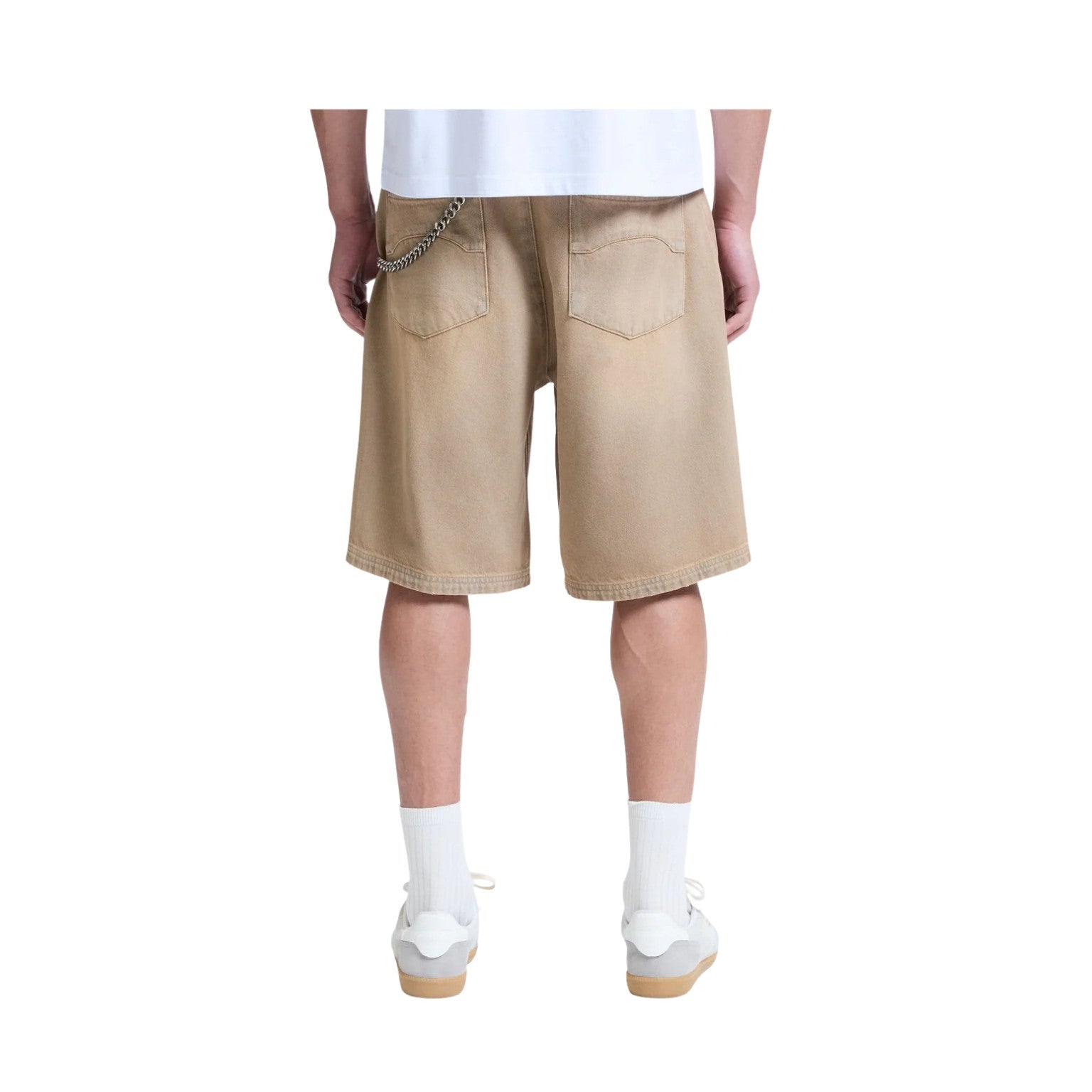 Beige shorts worn by a person on a white background