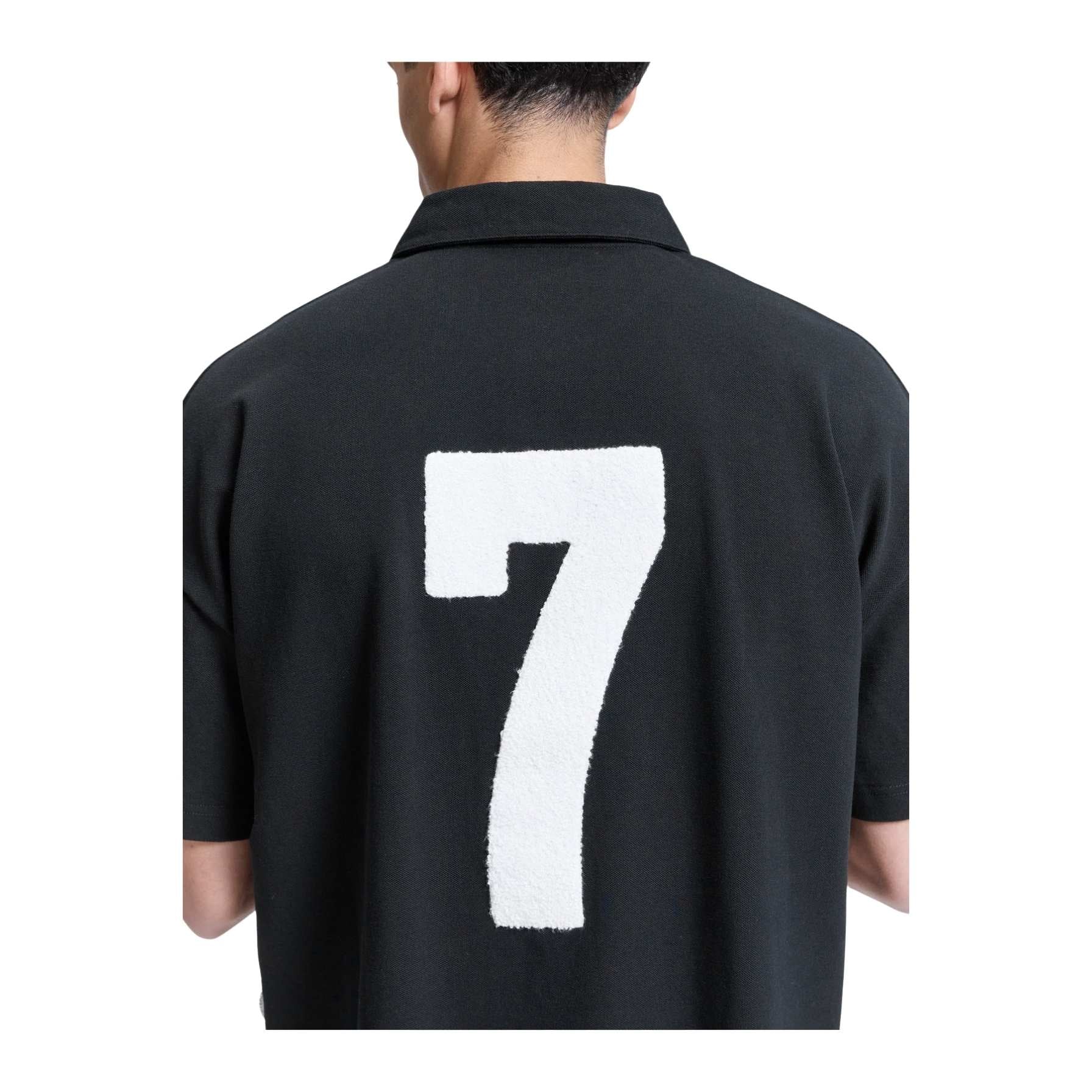 Black shirt with a white number 7 on the back, worn by a person.