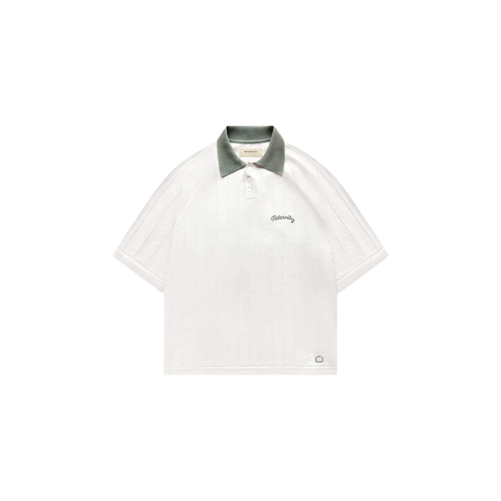 White polo shirt with green collar on a white background