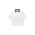 White polo shirt with green collar on a white background