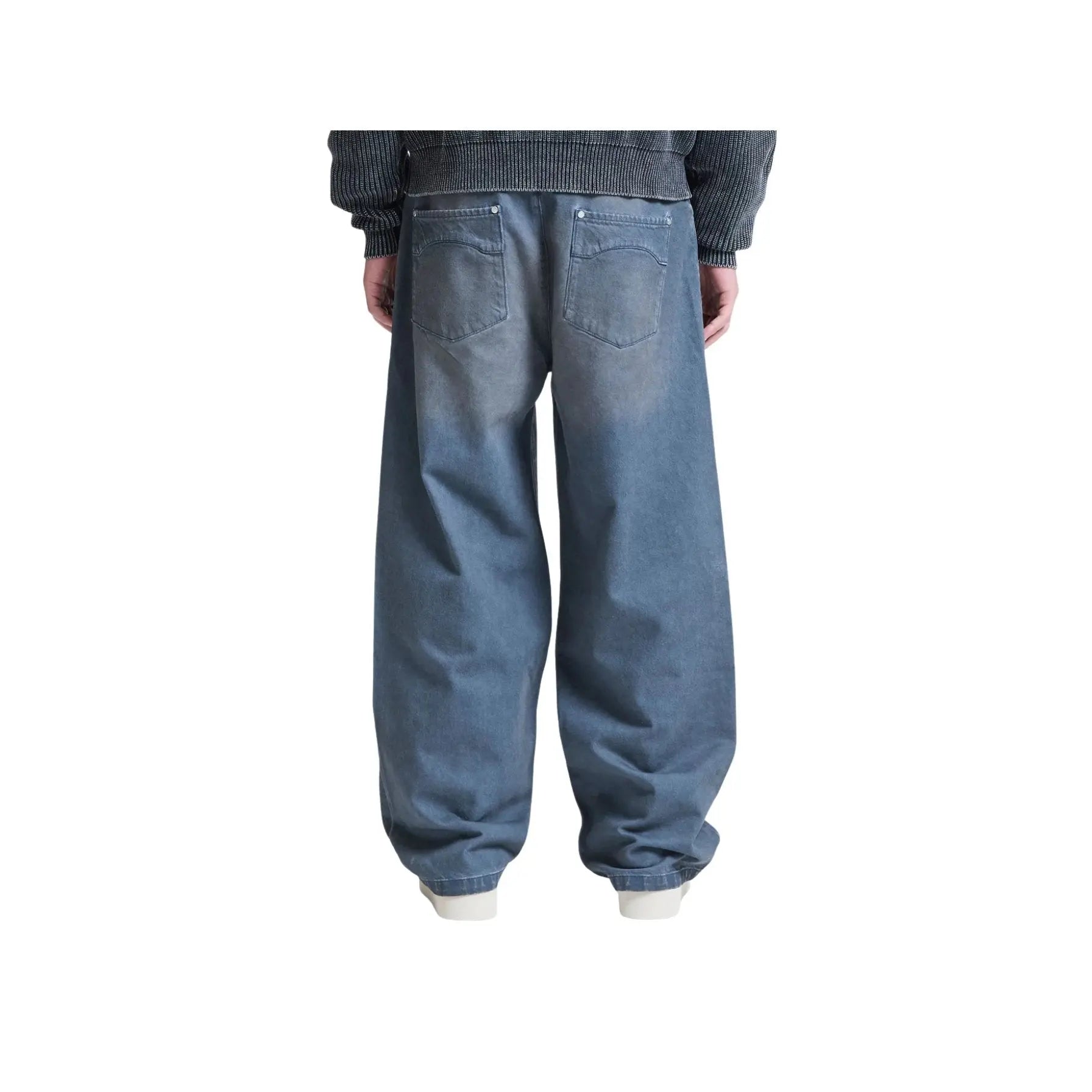 Person wearing blue jeans on a white background