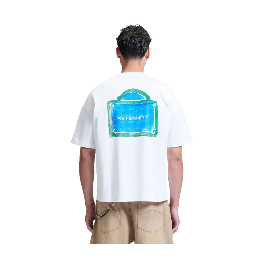 Person wearing a white t-shirt with a blue graphic and 'rEternity' text on the back, standing against a white background.