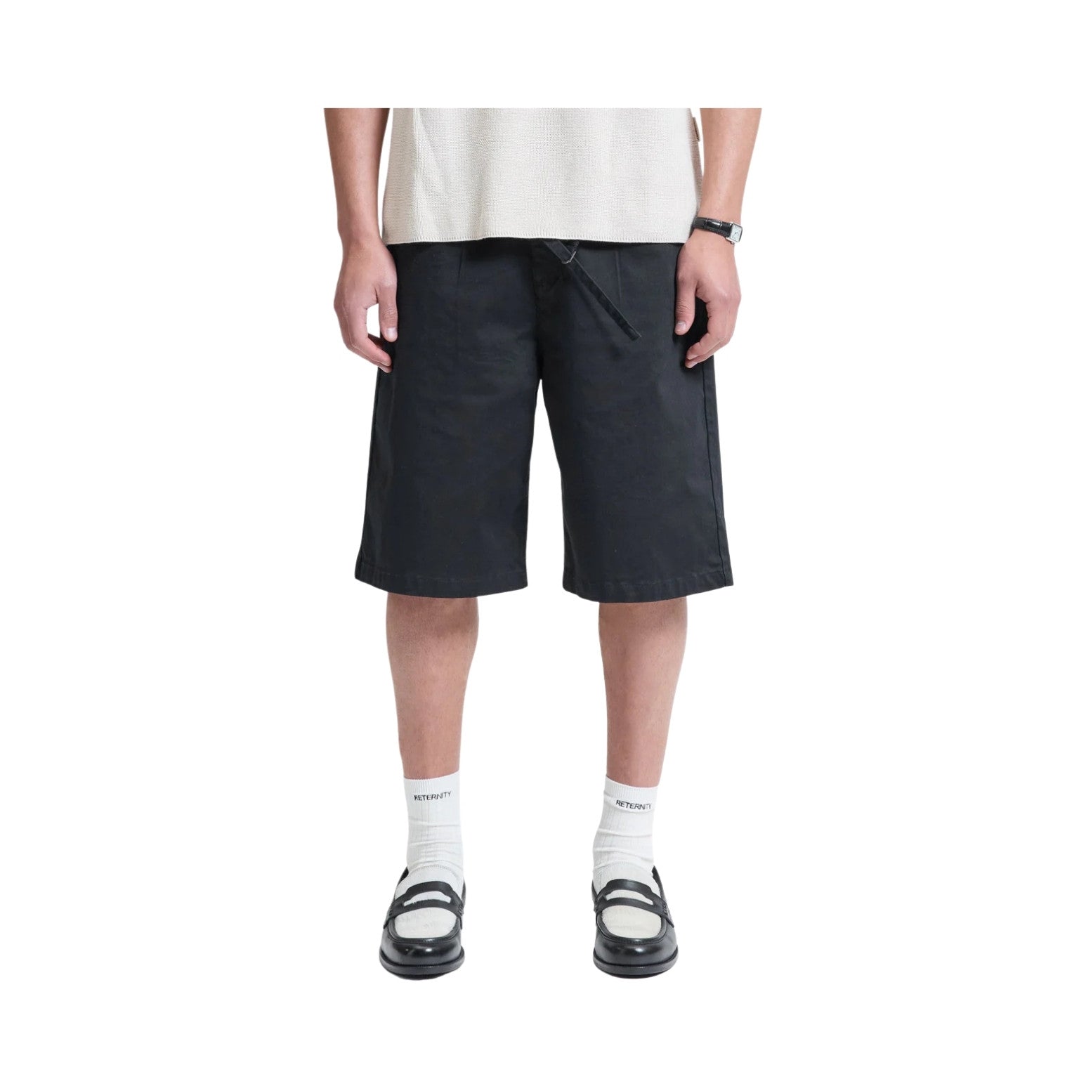 Person wearing black shorts on a white background