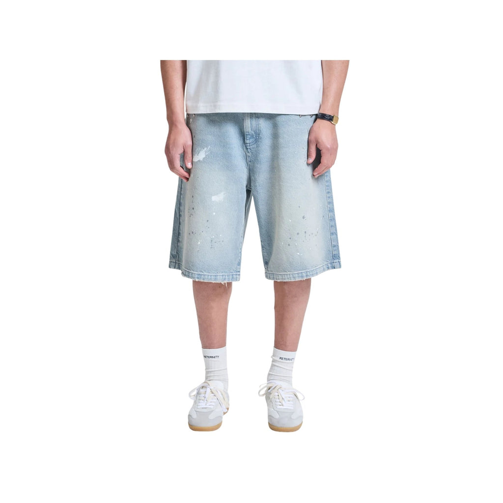 Person wearing light blue denim shorts on a white background