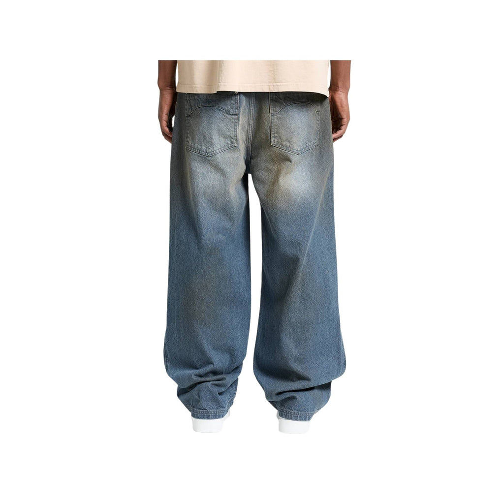 Blue jeans worn by a person on a white background