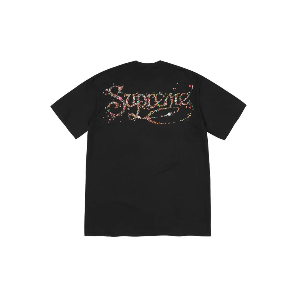 A black short-sleeve t-shirt shown from the back, featuring a large 'Supreme' logo across the upper back embellished with colorful rhinestones.