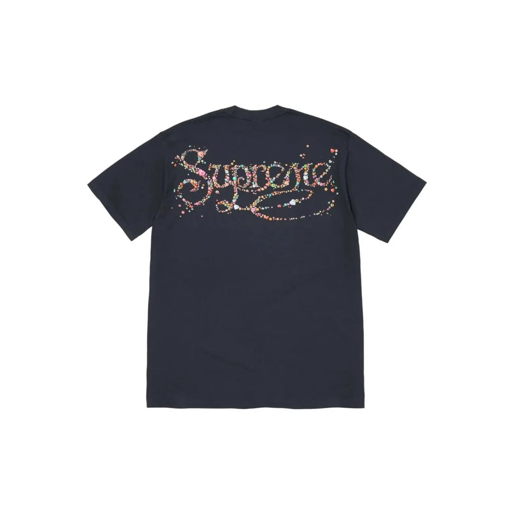 A black short-sleeve t-shirt with a large 'Supreme' logo across the chest, decorated with a colorful pattern of small stars and dots, shown on a plain white background.